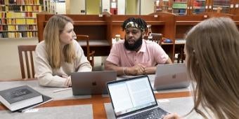 Students studying in a group in the library