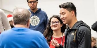 Students speaking with a faculty member